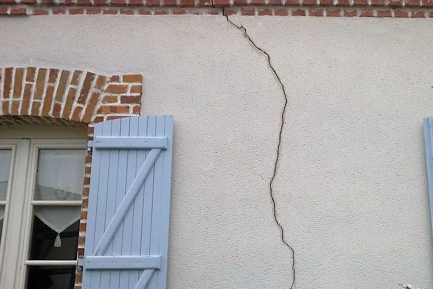 Maison individuelle avec fissures en façade après sécheresse
